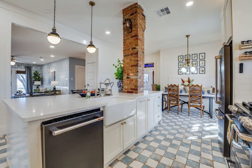 Open-concept layout with a farmhouse sink, oversized island, and bar seating—perfect for gathering and entertaining in style.