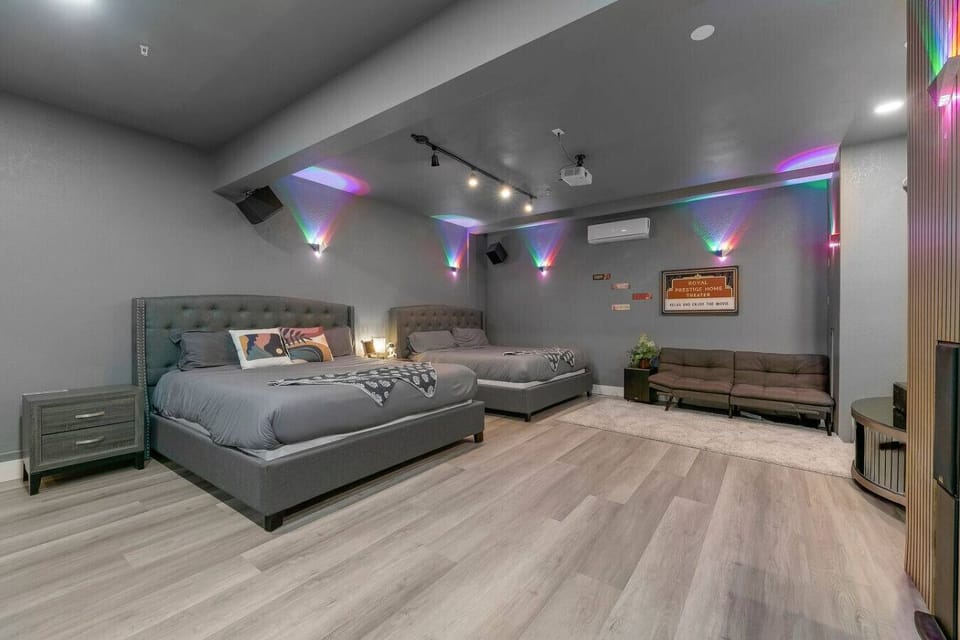 Theater Room: Unique entertainment space featuring a big-screen projector, cozy seating, and dual king beds.