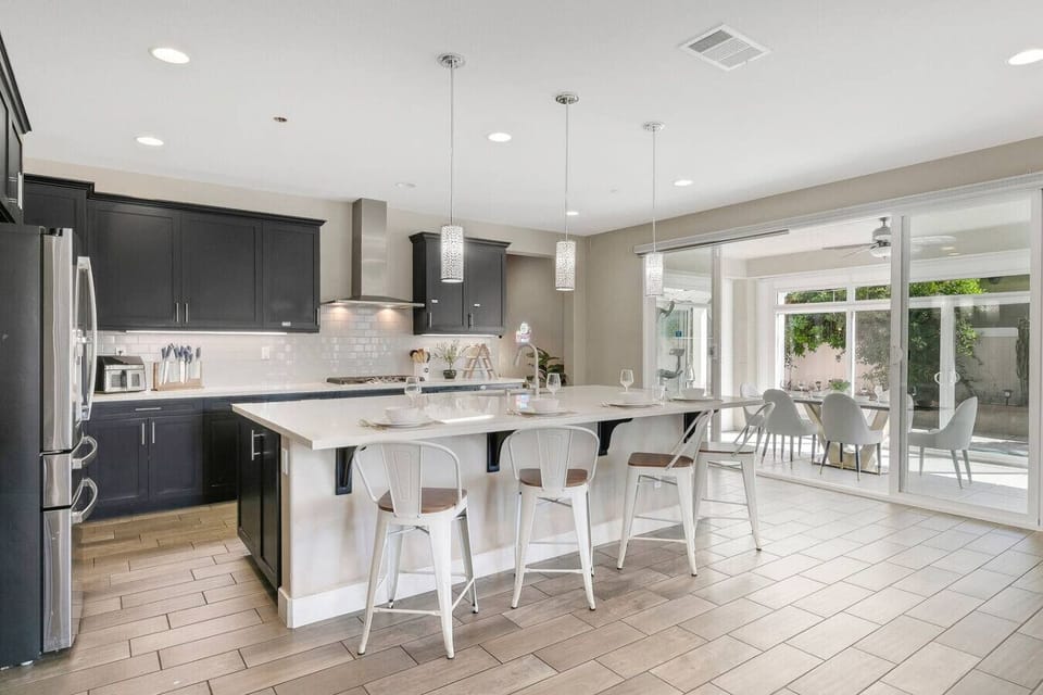 Spacious modern kitchen equipped with stainless appliances and large island for family dining.