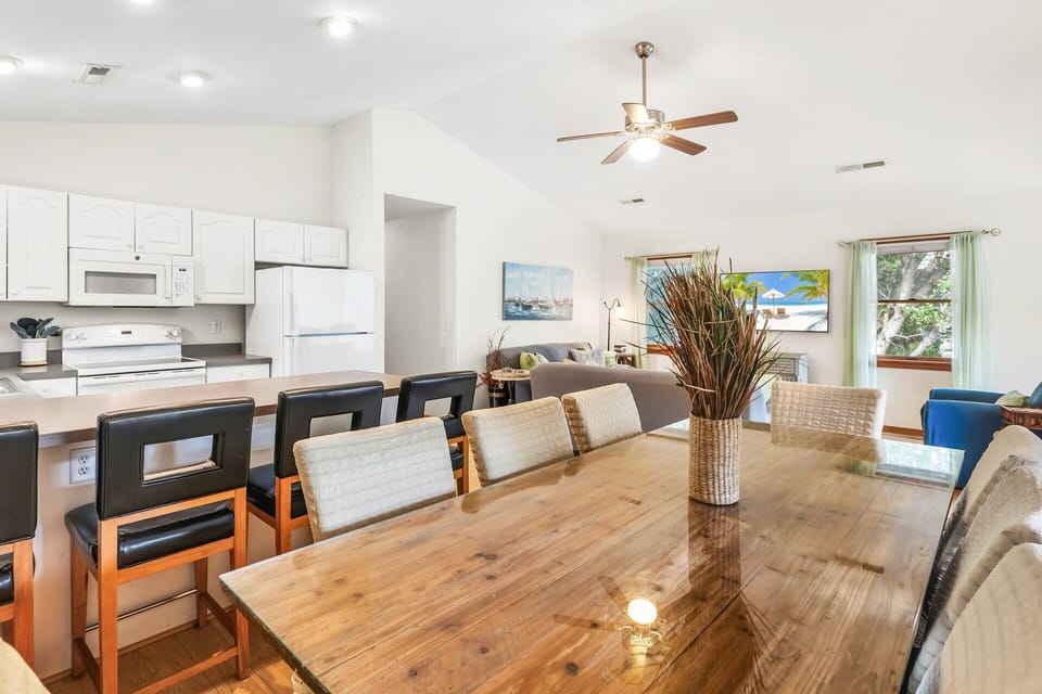 Kick back in the bright, open living area with cozy seating, a flat-screen TV, and access to the screened porch and sun deck.