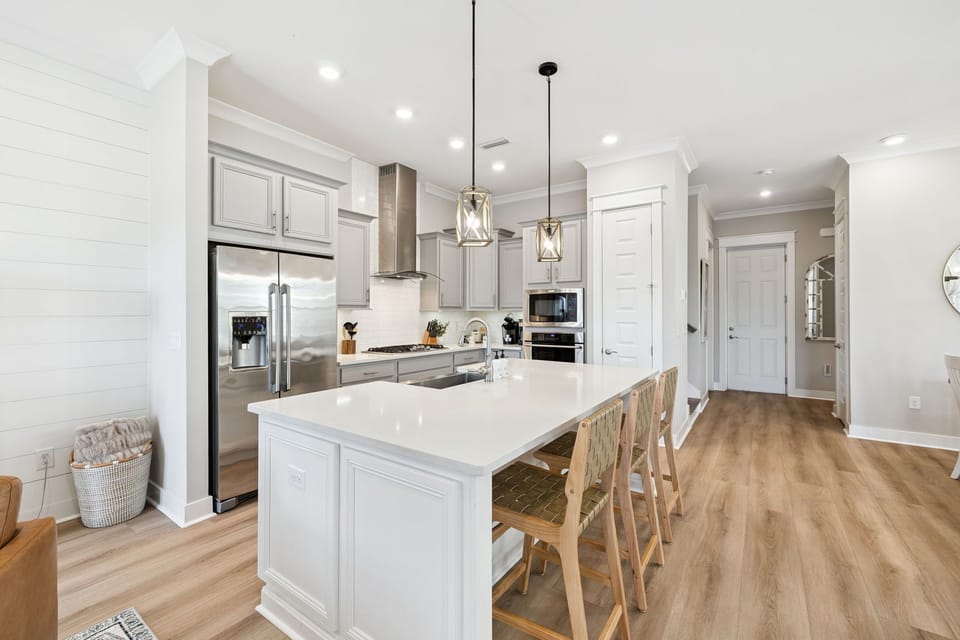 The spacious and bright kitchen is bound to become the hangout