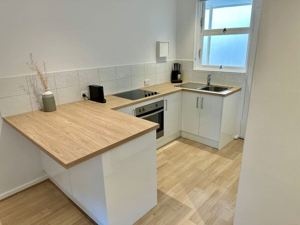 Cook with ease in the fully equipped kitchen, complete with a ceramic stovetop, full-size fridge, Nespresso coffee machine, and all the essentials for an unhurried stay.