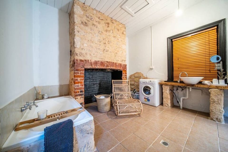 Make use of the washing machine conveniently located within the bathroom space.