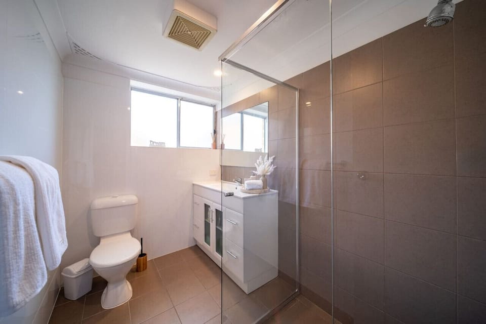 Refresh in the modern bathroom with a walk-in shower and clean, functional design.