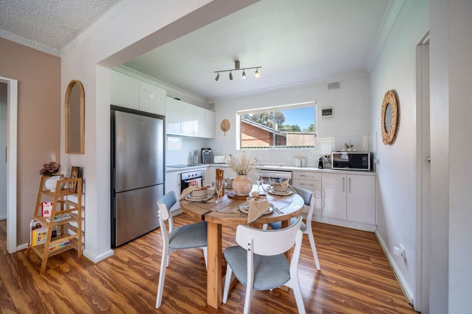 Gather around the dining table to share meals or plan the day in a bright, open setting.