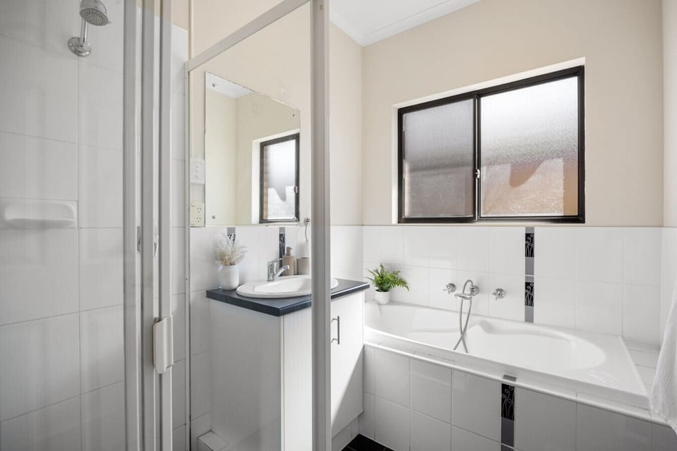 Enjoy a relaxing soak or refreshing shower in the main bathroom, designed for comfort and ease.