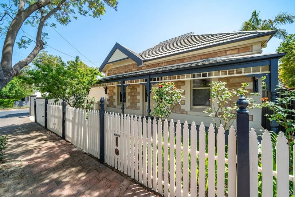 The 1910 sandstone facade and white picket fence make for a warm first impression on arrival.