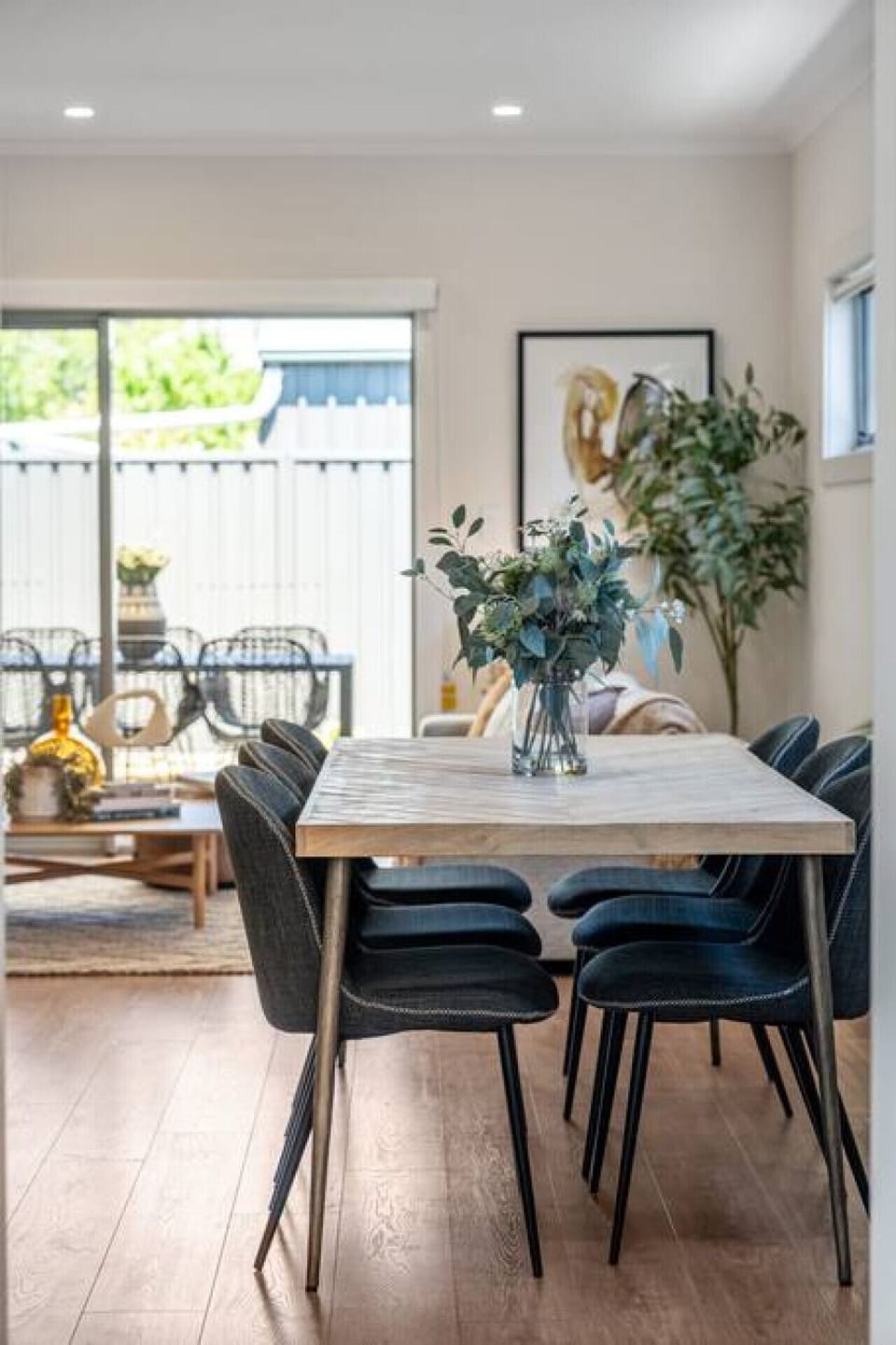 Enjoy a long dinner as evening light filters in, blending indoor comfort with the feel of relaxed city-fringe living.