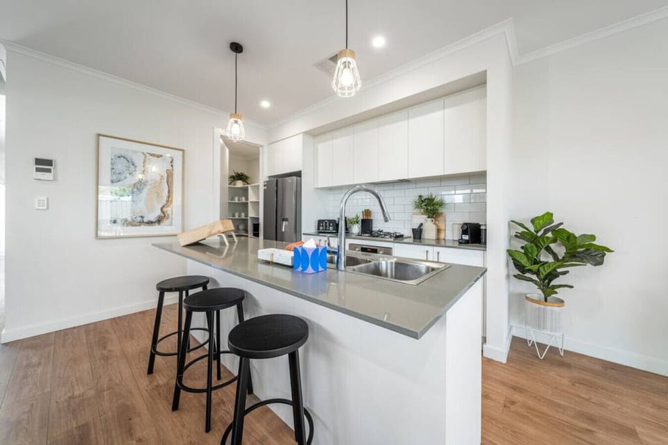 Cook with ease in a modern kitchen styled in sleek neutrals, complete with gas cooktop and thoughtful touches for effortless meals.