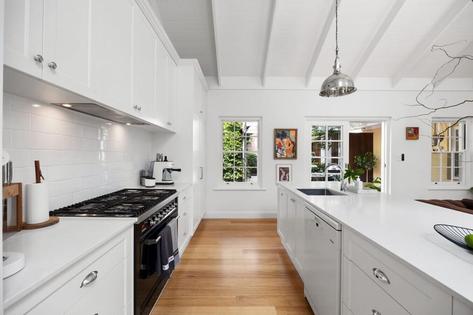 The kitchen offers a chef-friendly space with a gas cooktop, generous preparation surfaces, and understated styling for effortless cooking.