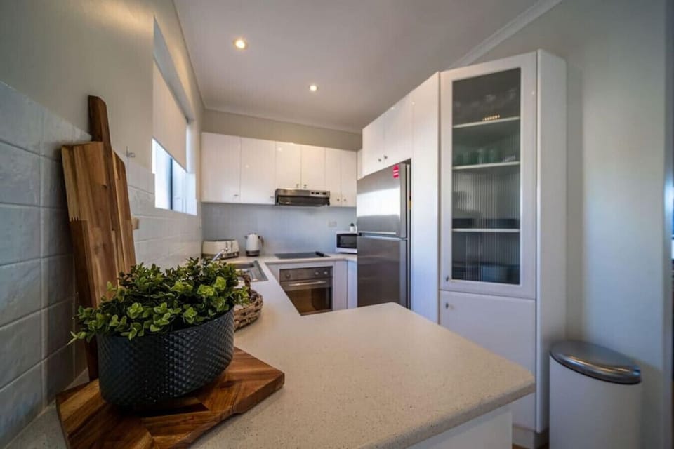 Bright and functional, the kitchen is set up for easy meal prep with ample bench space and modern appliances.