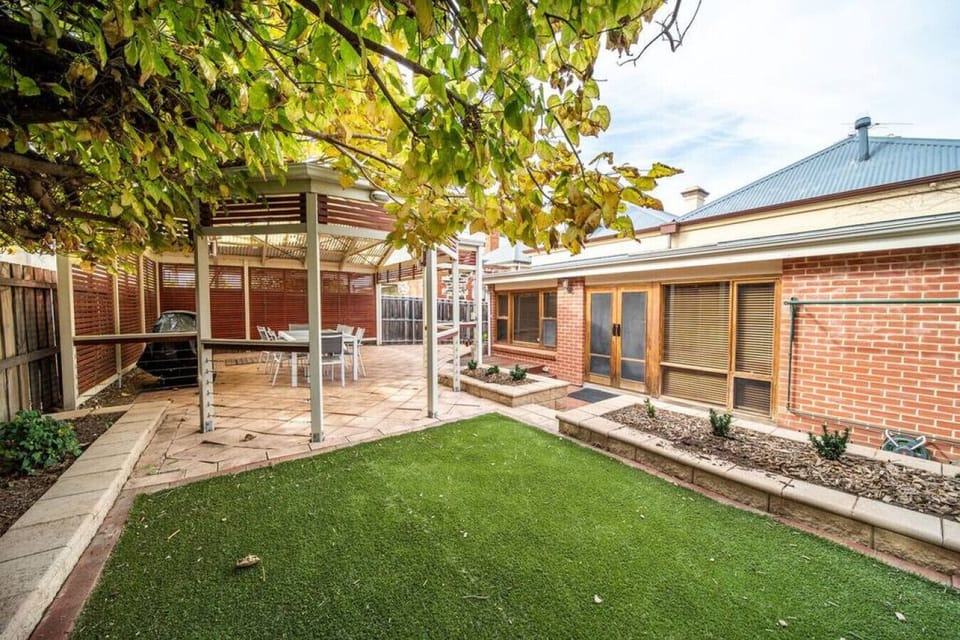 Enjoy a spacious backyard where greenery and open space invite outdoor relaxation.
