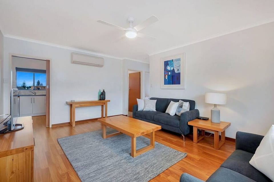 Open and welcoming, this space connects seamlessly to the rest of the home, offering a calm place to gather, read, or simply enjoy the gentle coastal atmosphere.