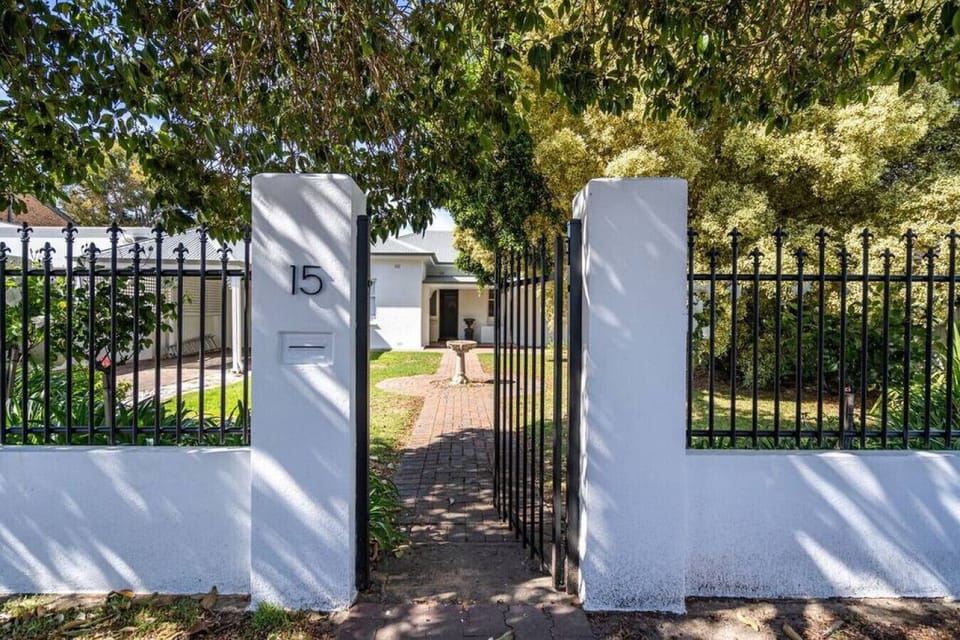 A gated entrance welcomes you to this charming home, surrounded by lush greenery and a timeless design.