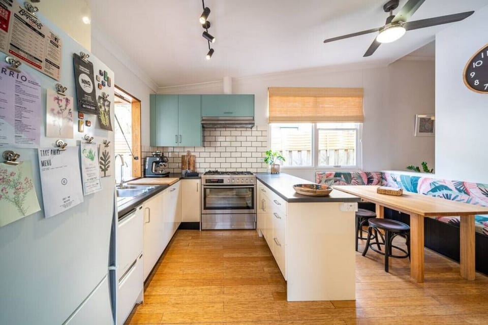 Start the day slowly in the cheerful kitchen, where morning espresso and easy breakfast prep set the tone before heading down to the beach.
