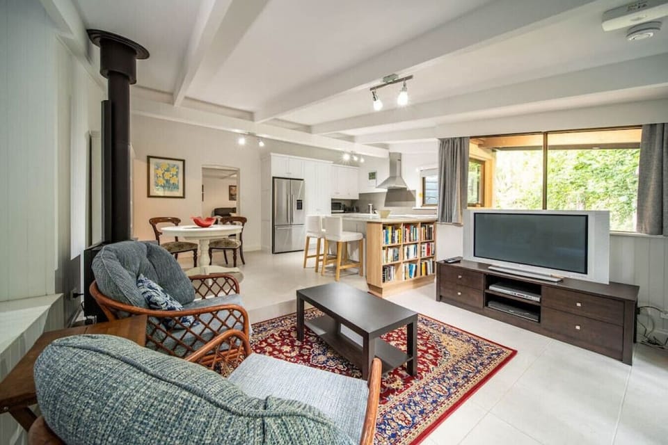 The living area features a fireplace, dining nook, and comfy chairs.