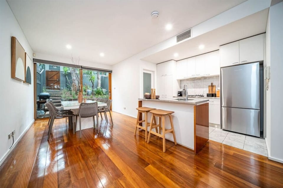 The kitchen and dinning area extends to a private courtyard with a Weber BBQ.