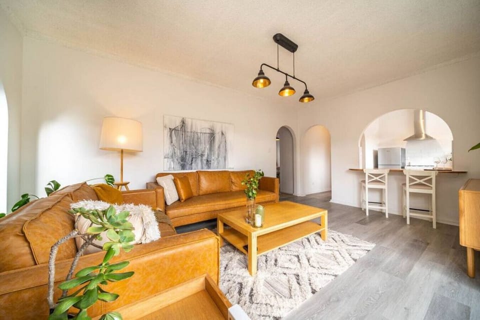 Warm tones and elegant design meet in this inviting open-plan living space.