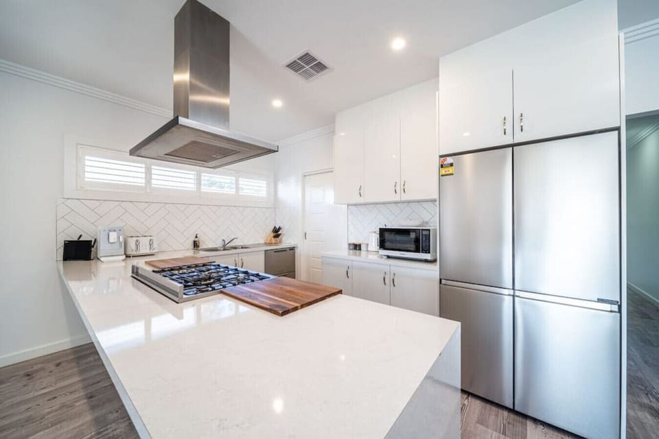Modern appliances and crisp white cabinetry make the kitchen bright and functional.