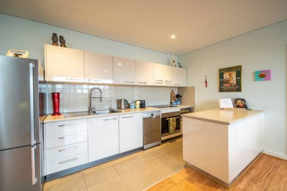Bright and functional, the kitchen is fully equipped for easy home cooking, with ample bench space and everything needed for relaxed stays.