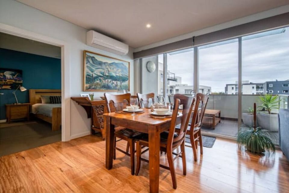 The dining area is filled with natural light and opens directly onto the balcony for easy breakfasts, shared dinners and evening drinks.