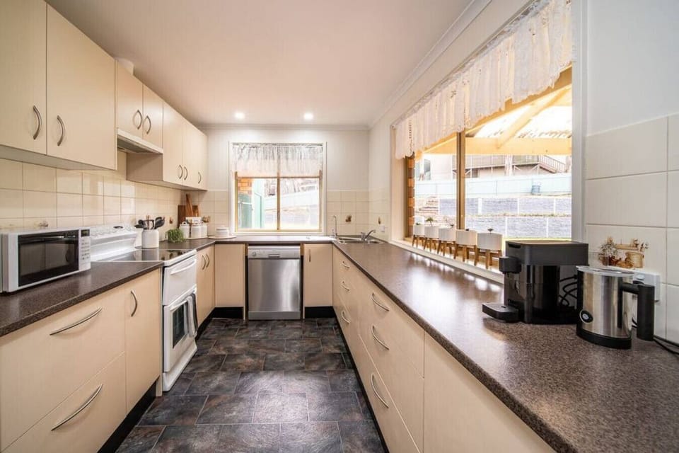 Prepare everything from quick breakfasts to long family dinners in the well-equipped kitchen, complete with modern appliances, generous bench space, and easy access to the dining area.