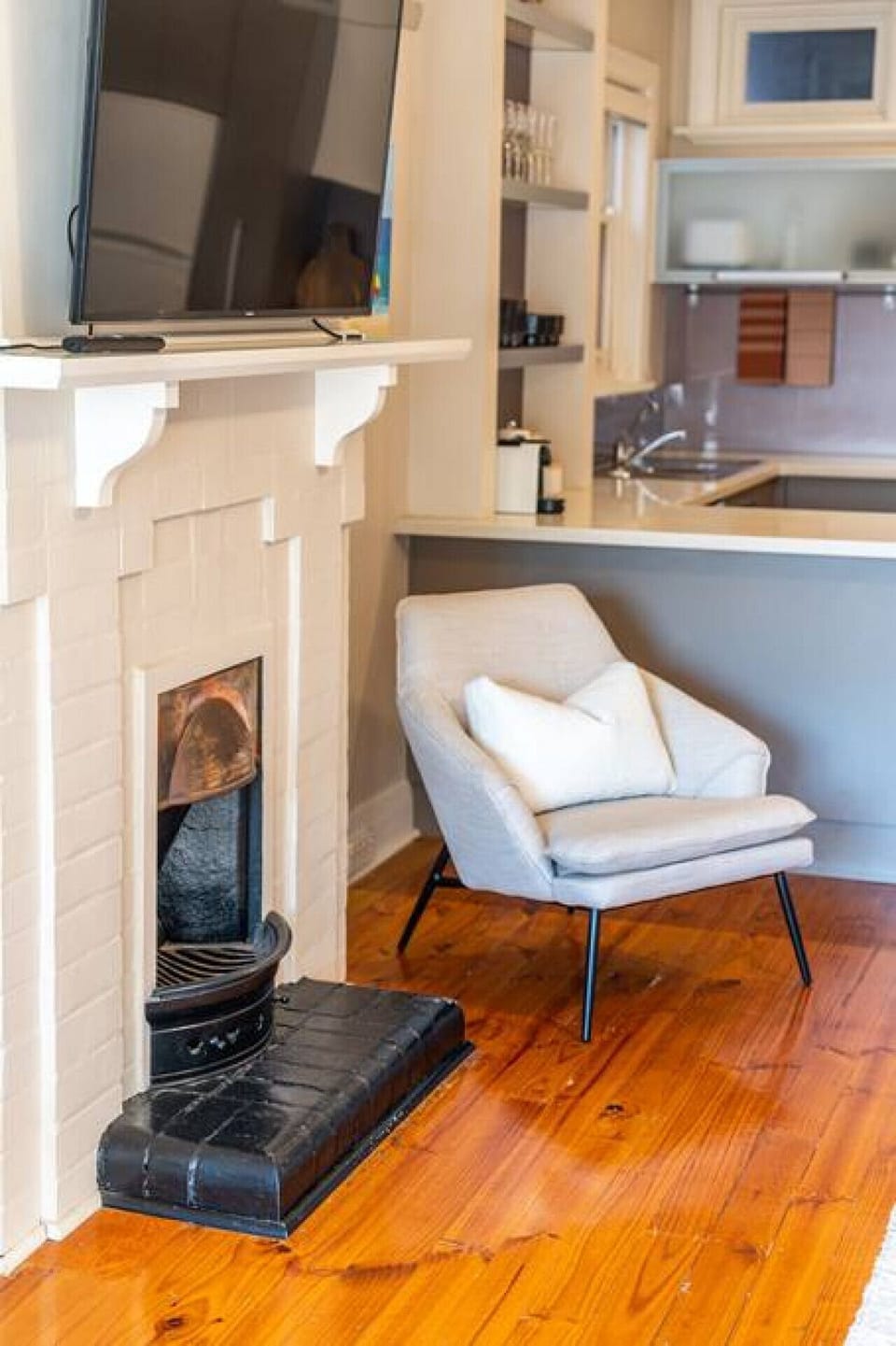 A vintage (not functional) fireplace adds a touch of charm to your stay.