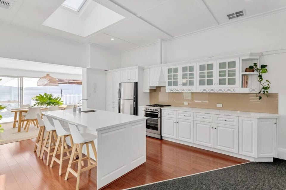 A gas cooktop, modern appliances, and island seating bring style and function together in the kitchen.