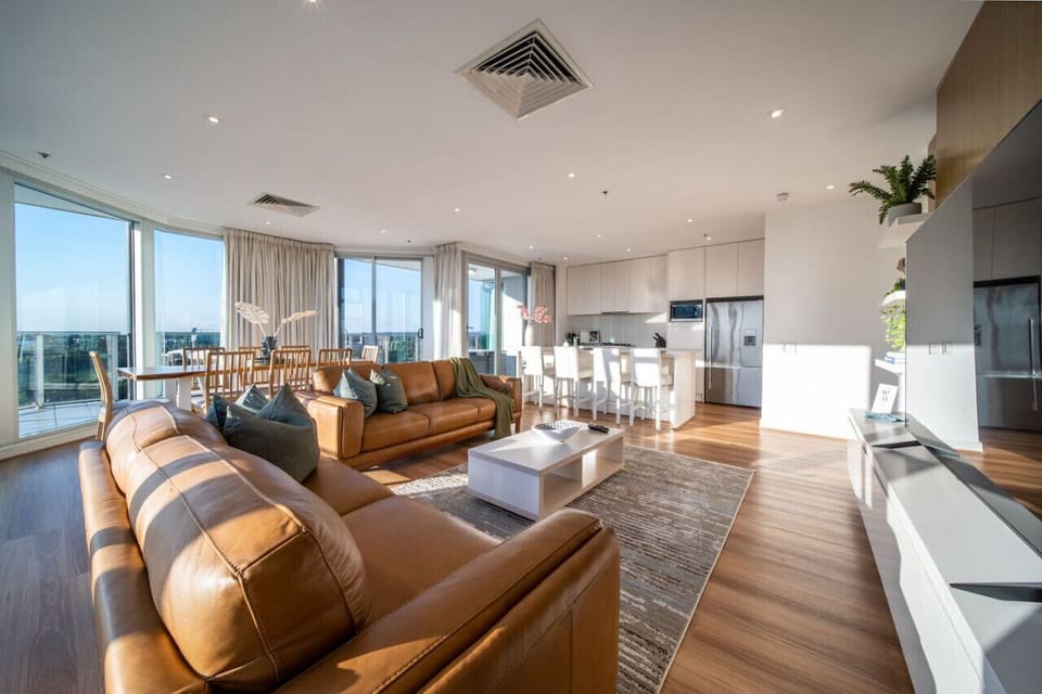 The open-plan design flows effortlessly between the living, dining, and kitchen spaces, creating a bright and welcoming setting for gathering, entertaining, or simply taking in the panoramic outlook.