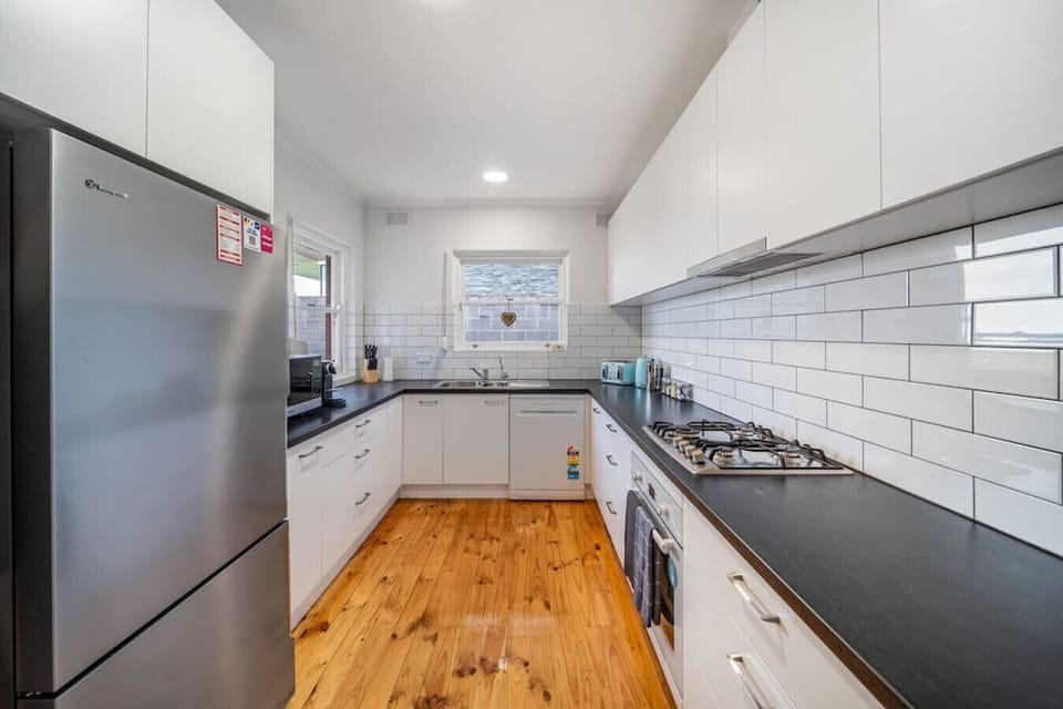 Prepare easy coastal meals in the bright kitchen before heading out for another swim or sunset walk along the beach.