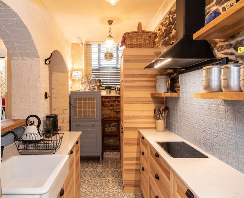 Sunlight and fresh air flow through the kitchen’s heritage windows, creating an inviting space to enjoy your morning coffee or unwind over tea.