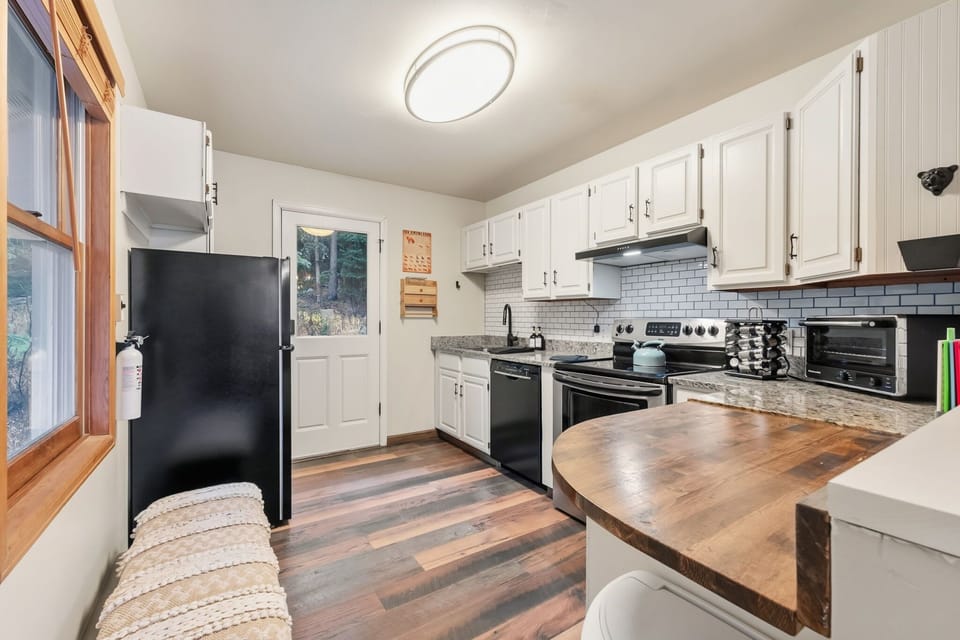 Kitchen: Main floor, drip coffee maker, blender, toaster, cooking utensils, tableware