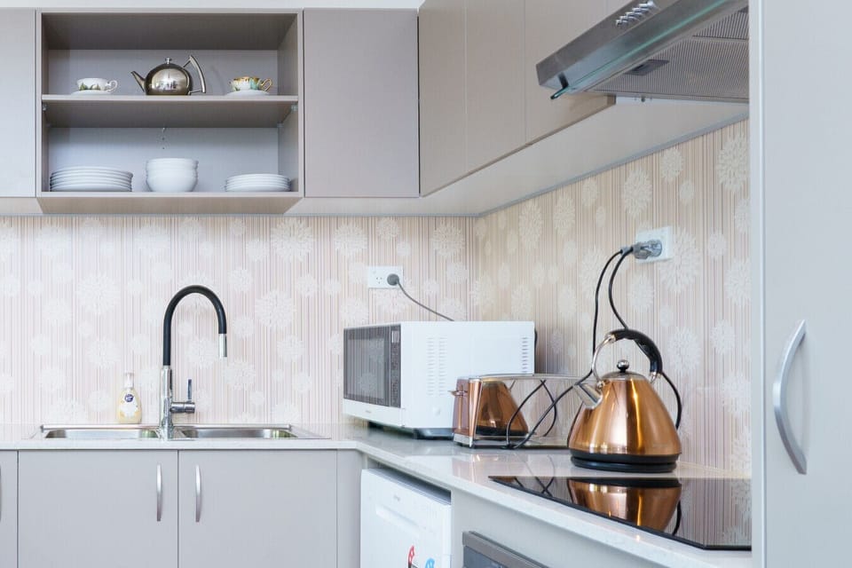 Sleek, modern kitchen with warm details and all the appliances at your fingertips