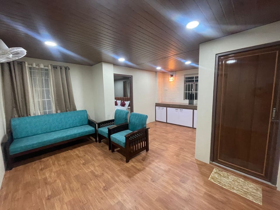 Family Suite, Balcony, Hill View | Living area | TV