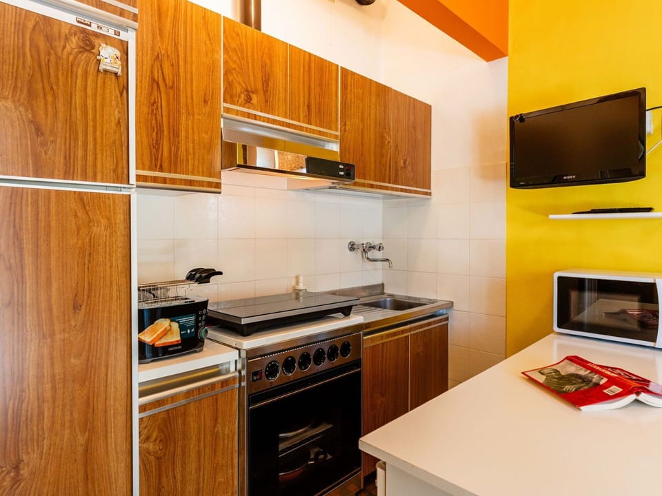 Kitchen, Major Appliance, Kitchen Appliance, Countertop, Wood, Yellow, Interior Design, Flooring, Cabinetry, Kitchen Stove
