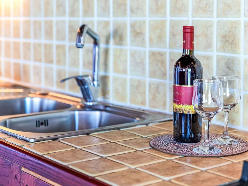 Flooring, Countertop, Kitchen, Kitchen Sink, Tile, Tap, Plumbing Fixture, Wood Stain, Kitchen Appliance, Cabinetry