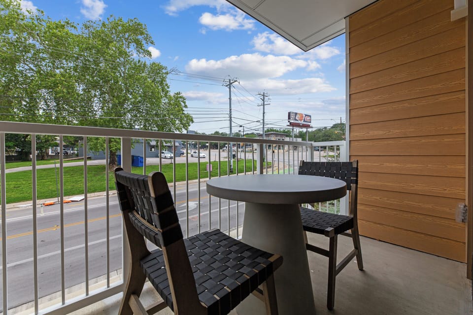 Sip your morning coffee or wind down in the evening from your private balcony with cozy seating and neighborhood views.