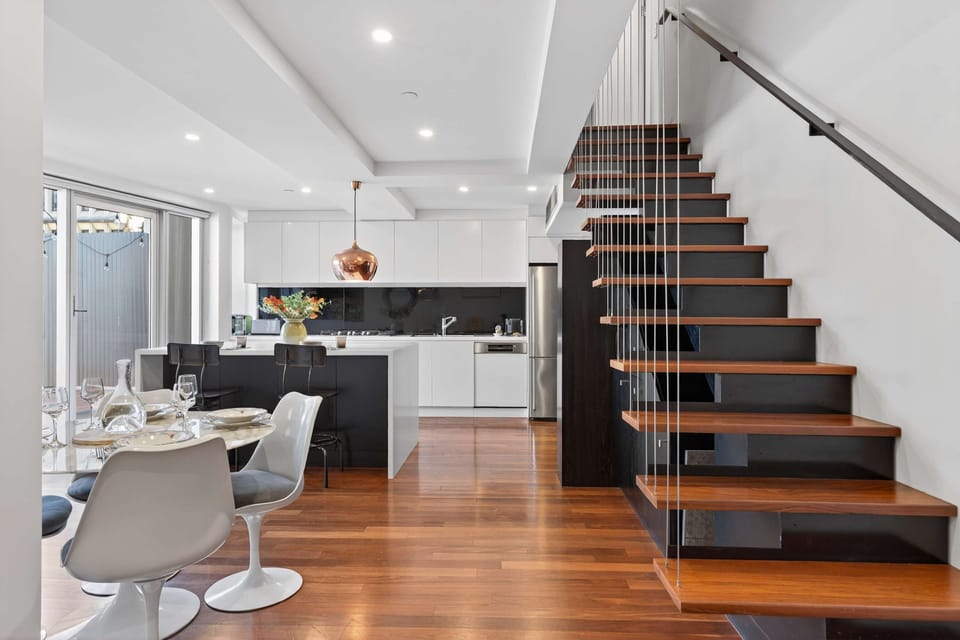Enjoy the open flow between the dining area, kitchen, and staircase to the upper floor.
