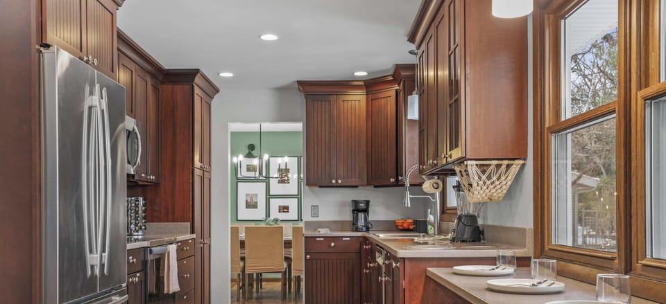 Fully stocked kitchen, with 4 barstools overlooking the backyard. We have a children's clip on high chair, kids dinnerware, complimentary coffee, tea, sugar, and creamer, as well as all your cooking needs on site.