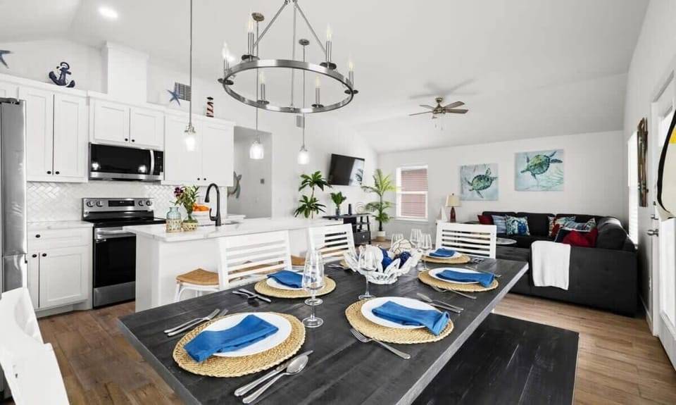 Open Floor Plan — Dining Table for 6, Ring Chandelier, White Kitchen & Dark Sectional