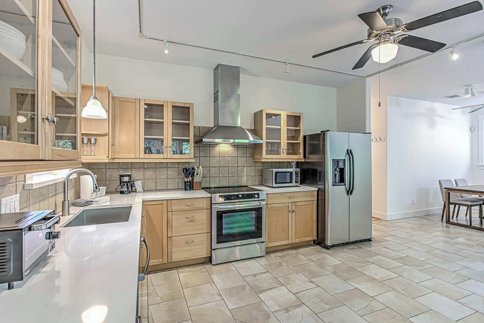 Bright, fully equipped kitchen with stainless steel appliances.