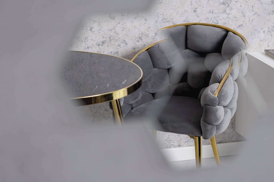 Close-up of the dining area with elegant gray chairs.