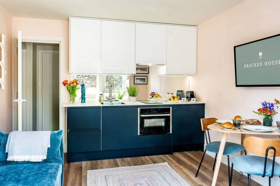 Lower ground living area with seating,  and small eating area perfect for two, leads through to the bathroom and bedroom in this self contained space, with internal stairs to the upstairs accomodation.