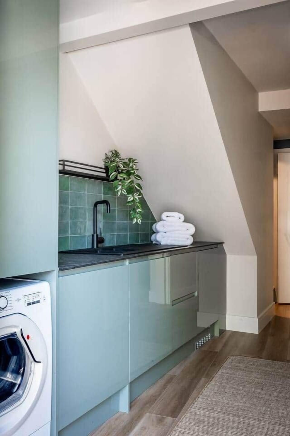 Utility area with washing machine tumbel dryer and additional freezer for larger parties. Iron and ironing board plus airer.