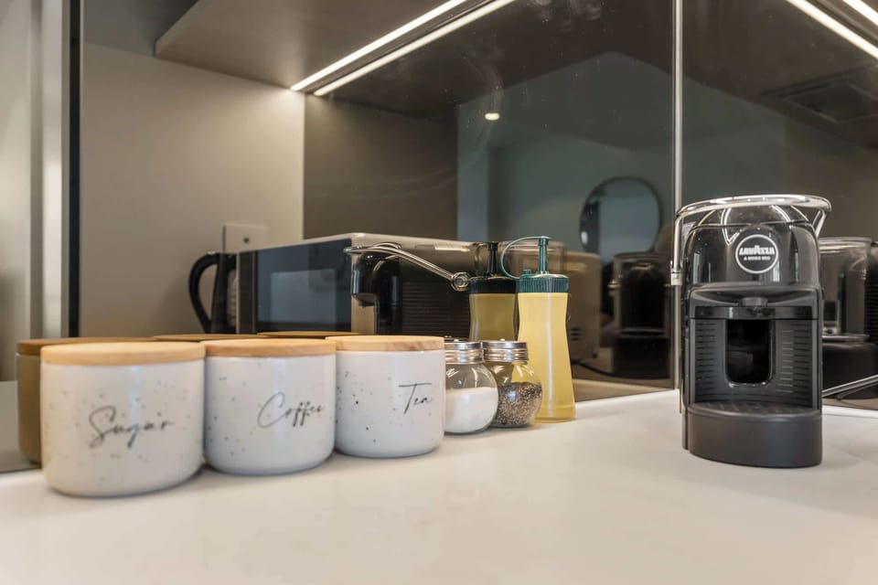 Enjoy complimentary Lavazza coffee pods with the in-room espresso machine, alongside tea, sugar, and cooking essentials for your stay.