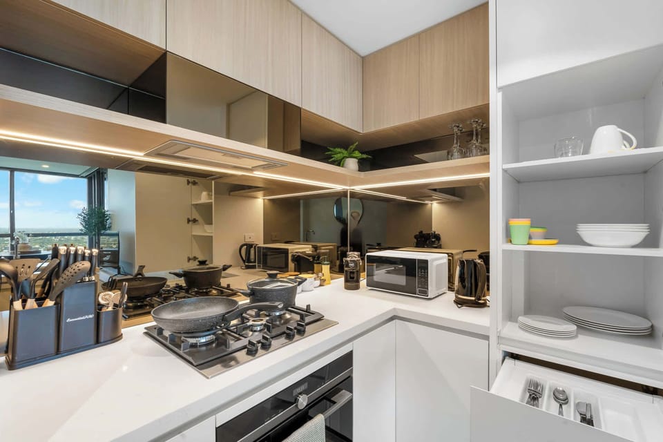 Fully equipped kitchen with microwave, oven, kettle, and cookware, perfect for both short visits and extended stays — all in refined Japandi style.