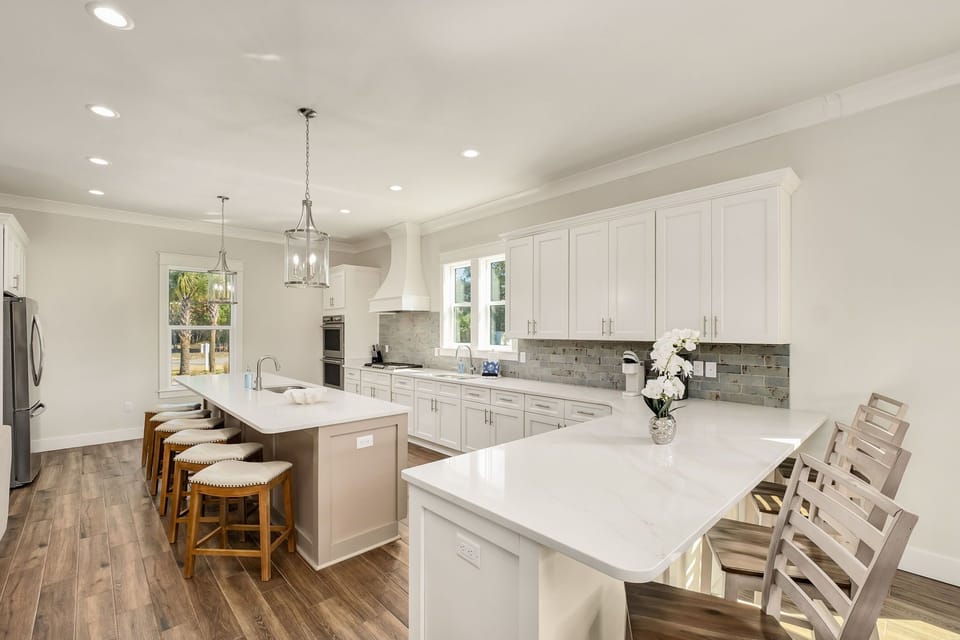 Bright, coastal-inspired kitchen with expansive island seating for gathering and entertaining.