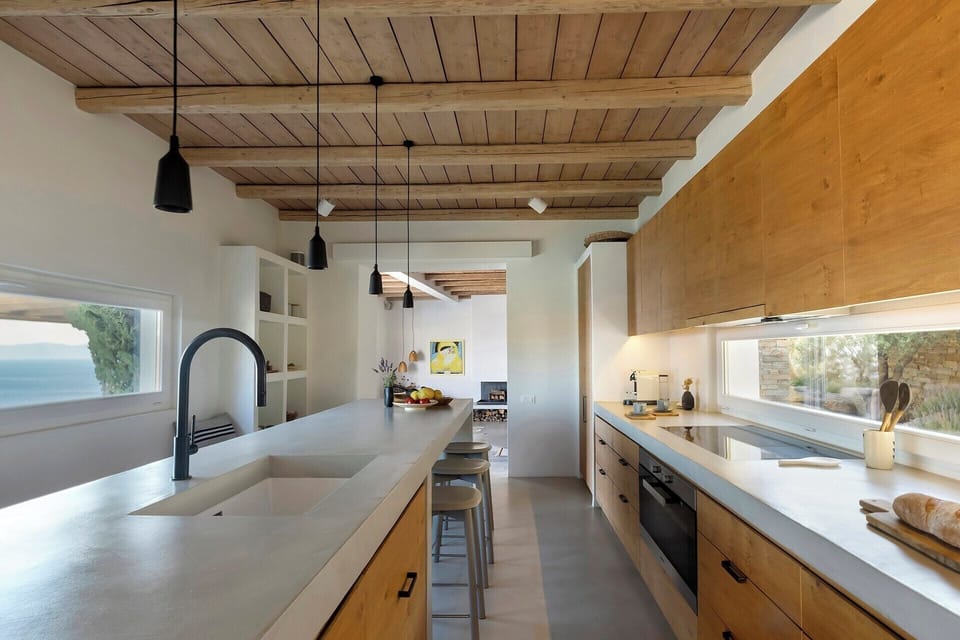 The splendid kitchen with its bespoke cabinetry, long island and sea views.