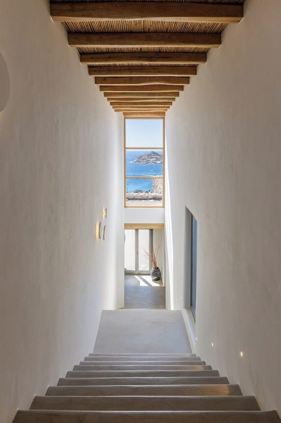 The elegant sweep of stairs leading down to the sleeping wing.