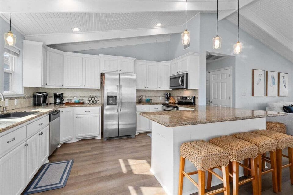 Fully equipped kitchen with large island and bar seating, perfect for entertaining in this Bolivar Peninsula rental.